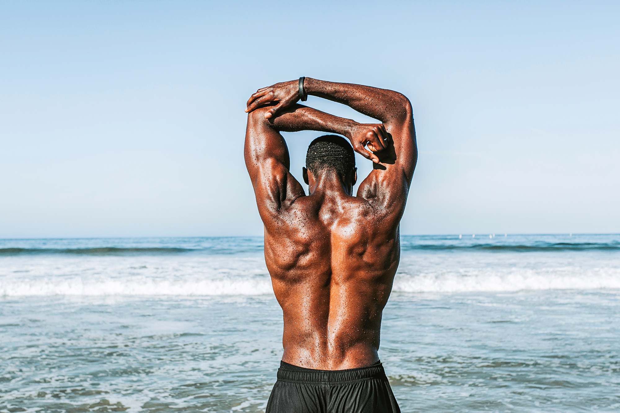 Athlete stretching on the beach ready for performance training